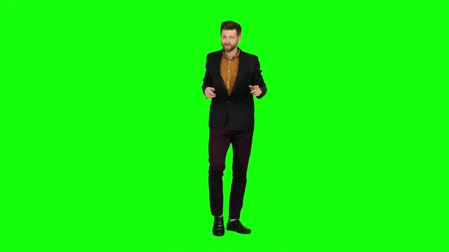 Man dances, flirts, winks, and there are eyes. Green screen