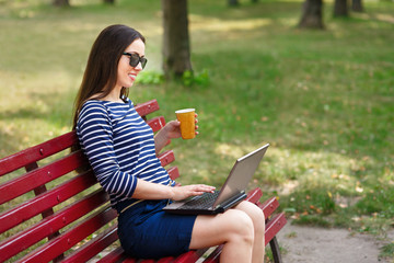 girl working on laptop in park