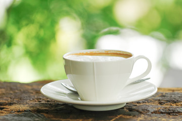 Stock Photo - White Coffee Cup on brown old wooden table with bokeh