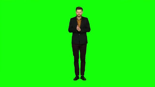 Young guy is happy with his victories, he is happy. Green screen