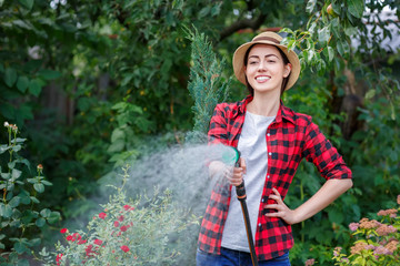 woman gardener watering garden