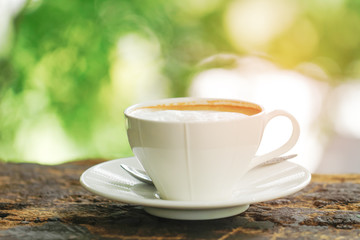 Stock Photo - White Coffee Cup on brown old wooden table with bokeh