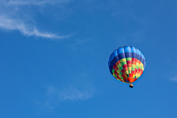 Fototapeta na wymiar Colorful hot-air balloon in flight