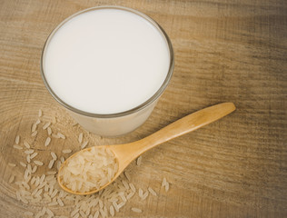 Rice milk on the wooden background .