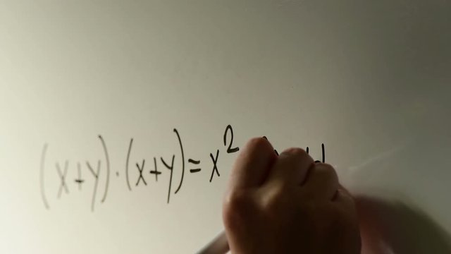 Polynomial function, math class in the school with teacher writing mathematical formula on white board