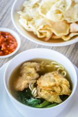noodle soup with fried dumpling and vegetables