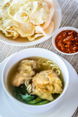 noodle soup with fried dumpling and vegetables