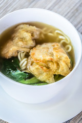 noodle soup with fried dumpling and vegetables