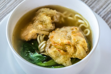 noodle soup with fried dumpling and vegetables