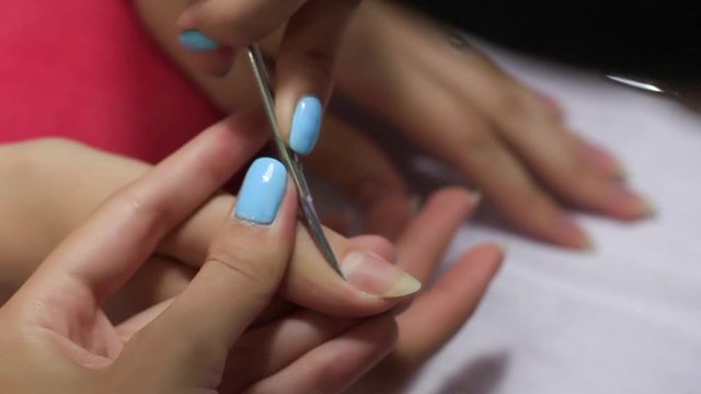 The girl is doing a manicure. Beautiful female hands. Beautiful nails.