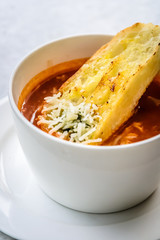 italian minestrone soup with garlic bread and grated cheddar cheese