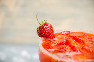 Cocktail strawberry margarita on the wooden background. Selective focus.