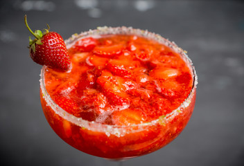 Cocktail strawberry margarita on the wooden background. Selective focus.