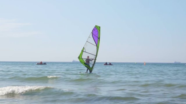 Zelenogradsk - May 2017 Russian  People learn windsurfing on the Baltic Sea in Zelenogradsk. In the background a dry cargo ship.