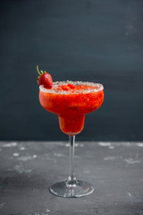 Cocktail strawberry margarita on the wooden background. Selective focus.