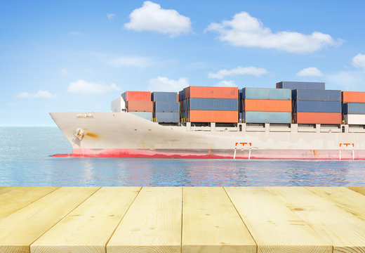 Cargo freight ship and cargo container in sea with blue sky for logistics and transportation background.