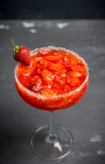 Cocktail strawberry margarita on the wooden background. Selective focus.