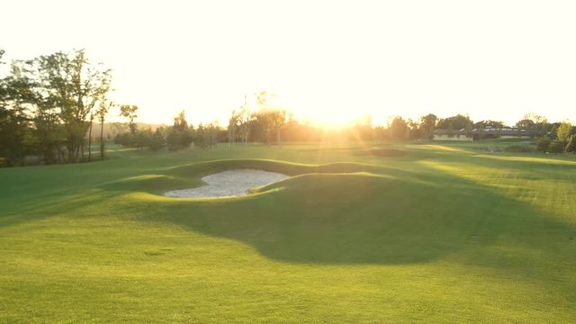 Sand bunker on golf field. Green lawn and sunshine. Where to play golf.
