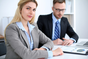 Successful business people working at meeting in office background