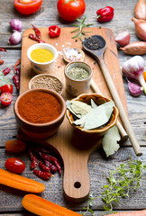 Spices and vegetables on wooden board