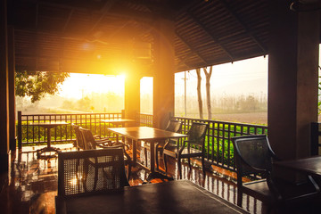 Restaurant kitchen interior concept : Empty outdoor restaurant tables at sunset light in the...