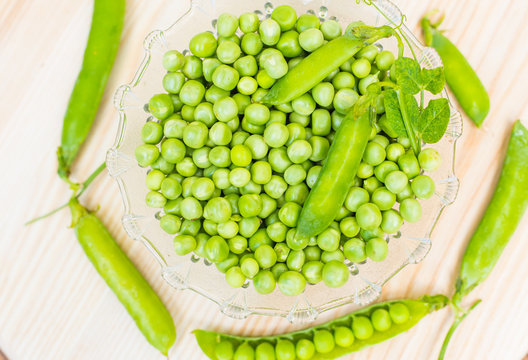 green peas dots on bright wooden background