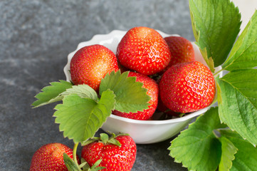 Juicy red strawberries and green leaflets