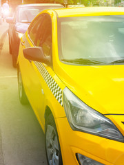 Yellow taxis in the city, sunset and flare, selective focus