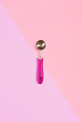 Ice cream scoop isolated on pink. Top view