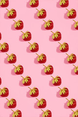 Colourful bright pattern with ripe strawberry. Top view. Pink background