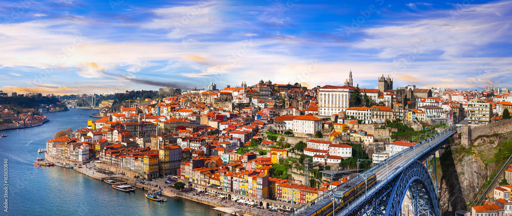 Wall mural panorama of beautiful Porto over sunset - view with famous bridge of Luis, Portugal