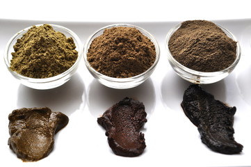 A selection of various natural henna (Lawsonia inermis) hair color dyes wet mixture isolated on...
