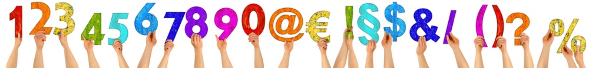 hands holding up colorful wooden letters number special character set collection/ Urlaub isolated...