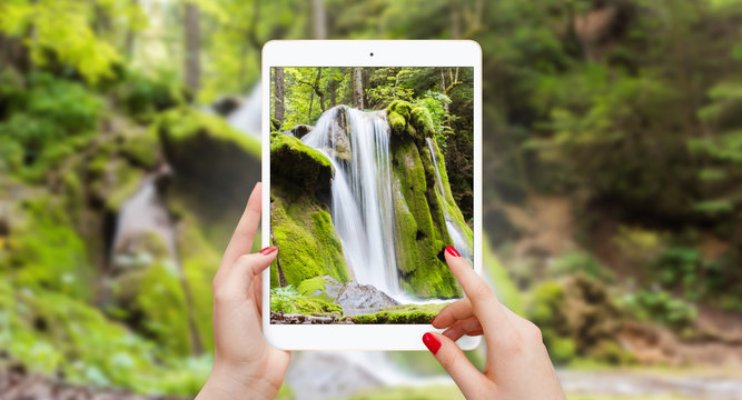 Taking picture of waterfall with tablet