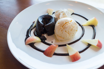hot chocolate lava cake with vanilla ice cream ball, apple and whipped cream