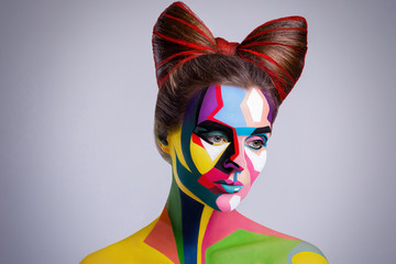 Model with a creative pop art makeup on her face.