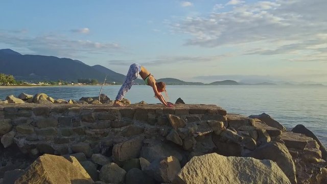 Drone View Girl Does Yoga against Tranquil Sea Hills
