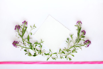 background for congratulations/ Installation of leaves and flowers decorated with a pink ribbon top view