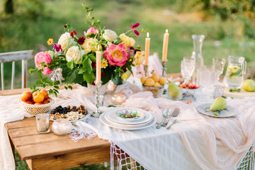 women's day, wedding, celebration, romance, picnic, nature concept - gorgeous table setting with...