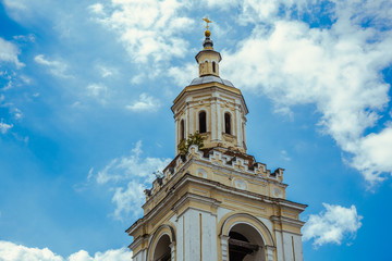 Ancient tower of an abandoned Orthodox church against the sky