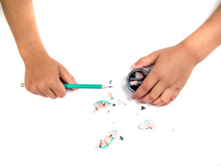 Kid sharpens a pencil
