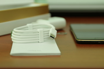 Black smartphone lying on a wooden table