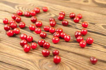 Red fresh cherries on old wooden background
