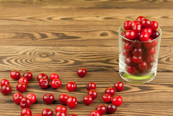 Cherries in glass on old wooden background