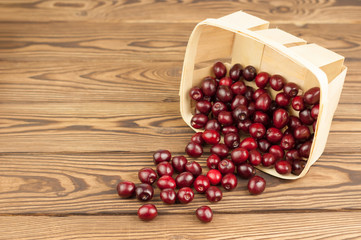 Red fresh cherries in bascet on old wooden background