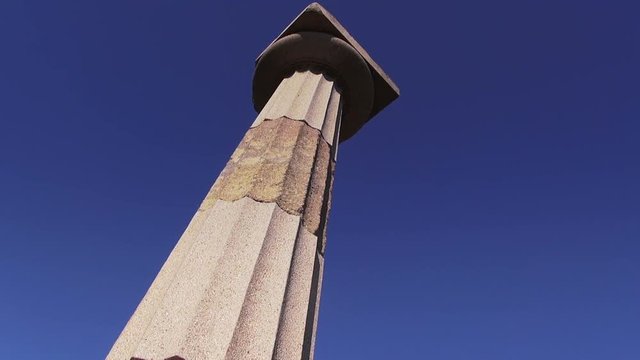 Antique column on blue sky background