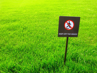 Warning sign on lawn. Keep off the grass.