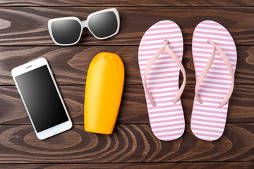 Overhead shot of pink flip flops on wooden background