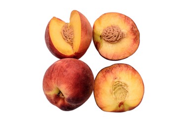 Peaches whole and sliced halves with a bone isolated on white background