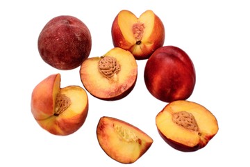 Peaches whole and sliced halves with a bone isolated on white background